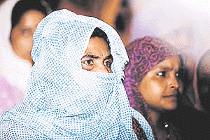 Women members of All India Safai Mazdoor Congress listening to the leaders at 34th annual sammelan of All India mazdoor congress at Talkatora stadium in New Delhi on Thursday