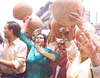 BJP activists carrying empty pitchers demonstrating against water crisis in Delhi on Friday