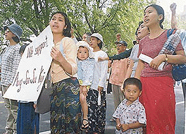 Children join their mothers as the Burma Democracy activists march in New Delhi on Saturday to present an open letter to the Indian Prime Minister to mark the 10th anniversary of the Noble Laureate Aung San Suu Kyi led National Leagues victory in the Burmese Parliamentary elections. Photograph