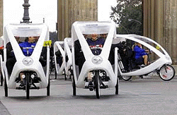 New designed velotaxis drive through the Brandenburg Gate during a presentation in Berlin on Tuesday