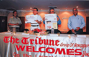 Mr S.D. Bhambri and Mr Hari Jaisingh displaying the copies of Ludhiana Tribune, which was launched at a glittering function in Ludhiana on Thursday. On the extreme right is Mr O.P. Arora