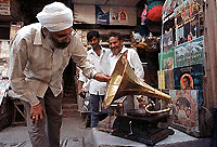 Antique collector Surinder Singh checks out an old gramophone at a streetside curio shop in Calcutta on Friday. Thousands of streetside shops crowd Calcutta�s roads, even though efforts had been made years back by the municipal government to clear them out.