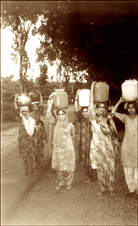 Women carry water in pots over long distances in the absence of water in pipes. A so-called fund shortage has hit water supply schemes of the Irrigation and Public Health Department