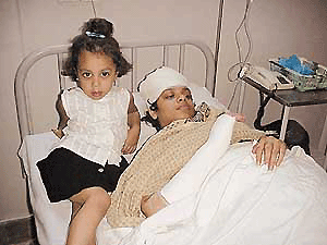 Meenu Gupta and her daughter, Shraddha, in a local hospital after they were assaulted by their servant