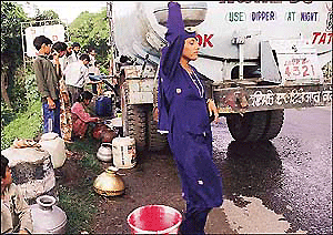 Kol dam notwithstanding , this is the plight of the people of Barmana in Bilaspur district of Himachal Pradesh for whom carrying water from tankers to their distant houses is an everyday occupation. � Tribune photo by Karam Singh