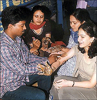 Youngsters get their hands adorned with the latest craze in one of the markets in Chandigarh.