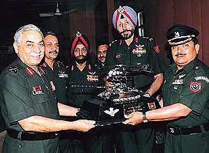 Lieut-Gen Oberoi, presenting the Flight Safety Trophy to Maj H. P. Patel, Officer Commanding No. 8 R and O Flight, at the Army Aviation Conference held in Chandi Mandir on Friday