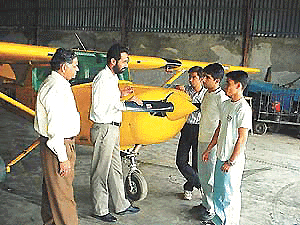 Flying instructor Captain Ahluwalia and engineer incharge S.K. Sharma with trainees at Ludhiana Aviation Club.