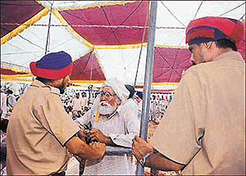 Policemen stop an old man from meeting the Chief Minister at Dhamot village in Ludhiana district on Friday.�