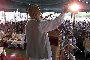    RAWALPINDI: Qazi Hussain Ahmed, Chief of the Jamat-i-Islami, Party of Islam, addressing traders in Rawalpindi, on Friday. Confrontation between traders and Pakistan's military-led government continues as merchants staged a rally protesting the government's plans to document business transactions and impose a 15 per cent sales tax. AP/PTI