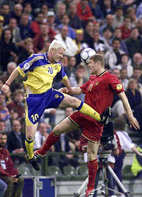 Sweden's Jorgen Petterson (left) and Belgium's Gert Verheyen go for a high ball during the opening game of the Euro 2000 soccer championships at the King Baudouin stadium in Brussels, Belgium, on Saturday