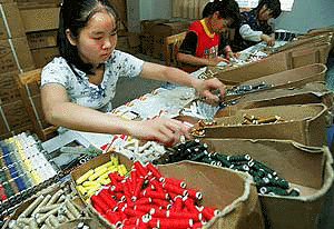 A worker packs rolls of thread at the workshop of private export firm Bluebreez Enterprises in the east China town of Ningbo on Monday