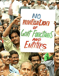 A government employee holds a poster during a protest rally against privatisation in Calcutta on Wednesday. Nearly 1,000 employees joined the rally to protest against moves to downsize government departments and privatise state-owned companies. � Reuters
