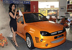 A model presents a Ford Ikon GT Model during an unveiling ceremony in New Delhi on Thursday. With modifications designed by Dilip Chhabria, Ikon GT is yet another addition to the country�s expanding small to medium car market which latecomer Ford hopes to stake a claim in. � AFP photo