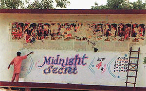 A worker in the process of whitewashing the advertisement of Midnight Secret at Capital Cinema in Patiala on Thursday.