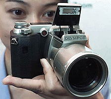 Olympus Optical Company�s new digital camera Camedia C-2100 Ultra Zoom at an unveiling in Tokyo on Thursday. � Reuters