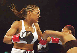 Laila Ali (left) lands a left hook to knock her opponent, Marjorie Jones, to the canvas during the first round of their bout at the Unversal Amphitheatre in Universal City, Calif., on Thursday. Ali knocked Jones out 68 seconds into the bout. 