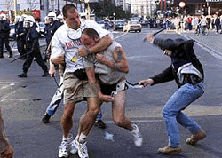 Plainclothes police officers try to detain a person thought to be an English soccer supporter