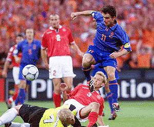 Marc Overmars (11) watches as his shot go wide as Denmark's Peter Schmeichel (eft) and Rene Henriksen put in a challenge during the EURO 2000 Soccer Championships
