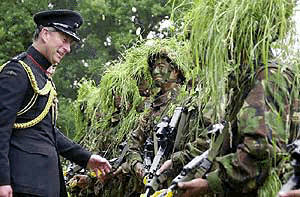 Britain's Prince Charles talks with two Gurkha soldiers