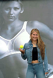 Russian tennis player Anna Kournikova poses in front of a poster of herself, while launching a new advertising campaign for Berlei Sports Bras, in Eastbourne, England, on Friday