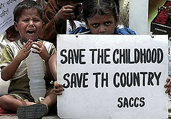 A child labourer holds up a placard demanding the abolition of child labour in India as another younger child (L) bursts into tears during a demonstration, 17 June 2000, in New Delhi. The aim of the demonstration was to call upon all countries to take urgent steps to stop "child slavery"  on the first anniversary of the adoption of Convention 182. According to International Labour Organisation (ILO) there are 250 million child labourers in the world, out of which 60 millon are in India. 