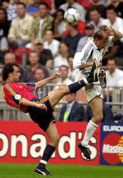 Slovenia's Amir Karic, right, and Spain's Joseba Etxeberria challenge the ball during a Group C match of the EURO 2000 soccer championships between Slovenia and Spain at the ArenA Stadium in Amsterdam on Sunday