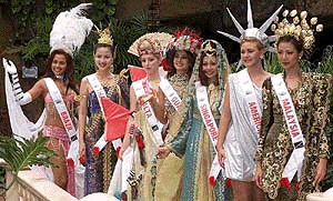Participants pose for photographers after a press conference for the 7th Queen of the Year International Pageant 2000 World Final in Kuala Lumpur Monday