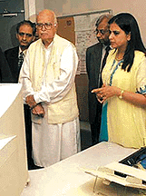 Home Minister L.K Advani and his daughter Pratibha listen to explanations during his visit to Interpol in Lyon on Monday.