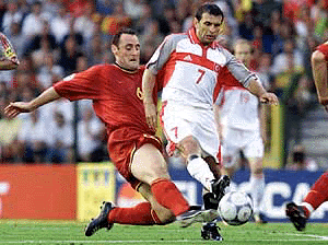 Turkey's Buruk Okan, right, is chased by Belgium's Yves Vanderhaeghe during their EURO 2000 soccer championships Group B match at the King Baudouin stadium in Brussels, Belgium, on Monday