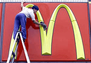 A Chinese worker cleans a sign at a McDonald's restaurant in Beijing on Tuesday. Foreign fast food is immensely popular in China, especially among the young and McDonald's has opened at least 230 restaurants in the country