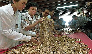 Thai foundation volunteers check gold jewellery given to Buddhist monks by Thai people in an effort to help the central bank refill the country�s gold reserves on Wednesday, before the gold is sent for refining into bars. � AFP photo