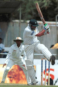 Pakistani batsman Inzamam-ul-Haq plays a stroke as Rassal Arnold looks on during the second day of the second cricket Test against Sri Lanka in Galle international cricket stadium in Galle, Sri Lanka, on Thursday