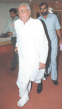 Haryana Chief Minister Om Prakash Chauthala with his leg in plaster arriving for the Chief Ministers Conference on state finance in New Delhi on Thursday. Photograph