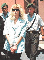 Alison McKinnon leaves court in handcuffs in Istanbul on Thursday. She was arrested in March after officials at Istanbul airport found heroin as she passed through security to board a plane for Britain. Turkish newspapers claimed she was caught after her intimate body piercing set off metal detectors at the airport