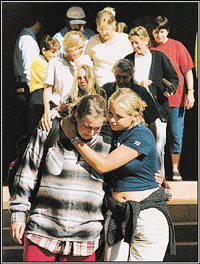 Survivors of the Palace Backpackers Hostel fire and some friends leavc a memorial service following a fire which killed 15 backpackers and left three unaccounted for in Childers in the state of Queensland on Friday