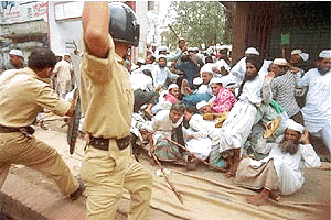 Police disperse hundreds of supporters of rival spiritual groups in Narayangonj district, 16 kilometers southeast of Dhaka on Friday. At least 100 people, including 25 policemen, were injured after the two groups clashed with police