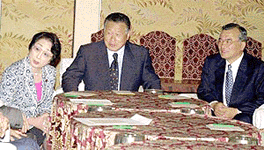 Leaders of three-party coation, from left, Chikage Ogi, of New Conservative Party, Yoshiro Mori, of Liberal Democratic Party, and Takenori Kanzaki, of New Komeito Party, speak to other party officials at a meeting of the coalition following Sunday's lower house election in Tokyo Monday, June 25, 2000