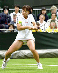 Japanese player Yuka Yoshida returns a ball to her compatriot Ai Sugiyama during their 1st round match at the Wimbledon 2000 tennis tournament on Monday