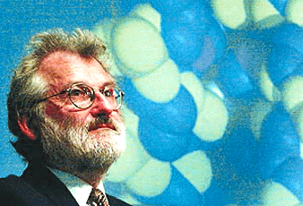 Dr John Sulston, Director of the Sanger Centre, speaks in front of a genetic model at the Human Genome Project press conference at the Wellcome Trust, London, on Monday