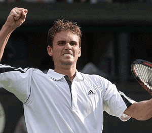 Jan-Michael Gambill of the US reacts, after defeating Australia's Lleyton Hewitt, seeded seventh in their Men's Singles, first round match on the Centre Court at Wimbledon, on Tuesday