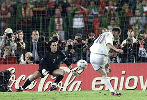 Zinedine Zidane of France slots home the golden goal winner from the penalty spot past Portugal's Vitor Baia during the EURO 2000 Soccer Championship semi final match between Portugal and France at the King Baudouin stadium in Brussels, on Wednesday 