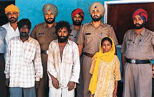 The police party with the three accused � Shanker, Baba Om Parkash and Tara after their arrest.