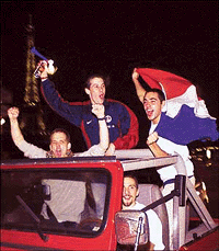 Parisians celebrate victory near the Eiffel Tower as they ride in a jeep through Paris � Reuters photo