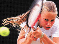 Australian Jelena Dokic plays a backhand return to Kristina Brandi of the USA during their fourth round match at the Wimbledon Tennis Championships on Monday