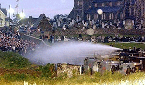 The British Army and the Royal Ulster Constabulary hold back Loyalist protestors.