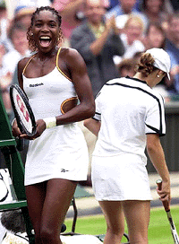 Venus Williams of the US reacts after defeating Switzerland's Martina Hingis, right, in their Women's Singles quarter-final on the Centre Court at Wimbledon, on Tuesday