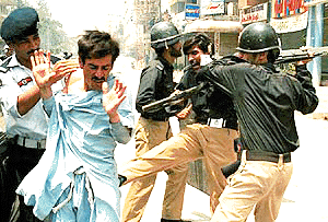 Pakistani policemen baton-charge traders in Rawalpindi on Thursday, the second day of violent anti-tax protests. The protests were against a campaign launched by Gen Pervez Mushrraf's Government to trace tax evaders and register retailers for a general sales tax