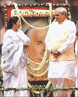 Indian Prime Minister Atal Behari Vajpayee and his key regional ally Railway Minister Mamata Banerjee stand besides the portrait of Shyama Prasad Mukherjee in eastern Calcutta on Thursday