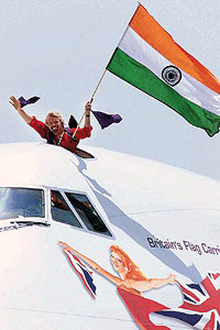 Richard Branson, chairman of Virgin Group, waves the Indian tricolour from Virgin Atlantic Airline's inaugural flight to India in New Delhi on Thursday